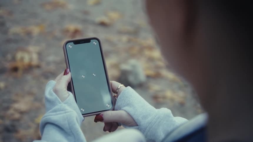 The woman turns her cell phone