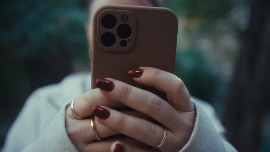 A woman using a smartphone outdoors