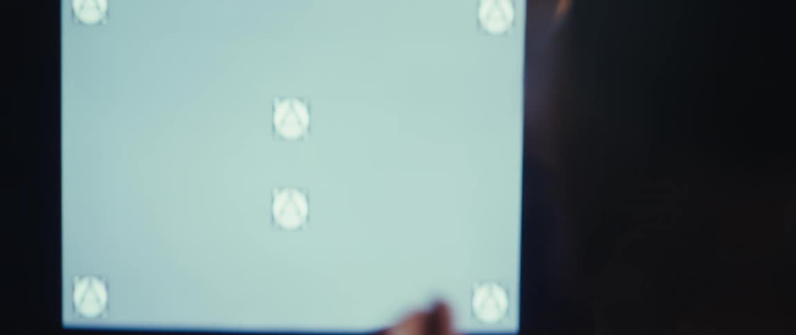 A man claps while sitting at home in front of his television screen
