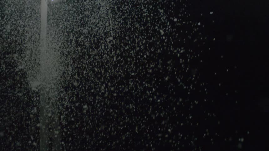 Suspended particles lit from the side in a dark background
