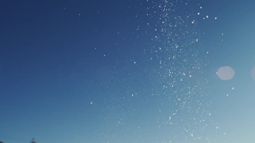 Snow falling from the sky outdoors during day time