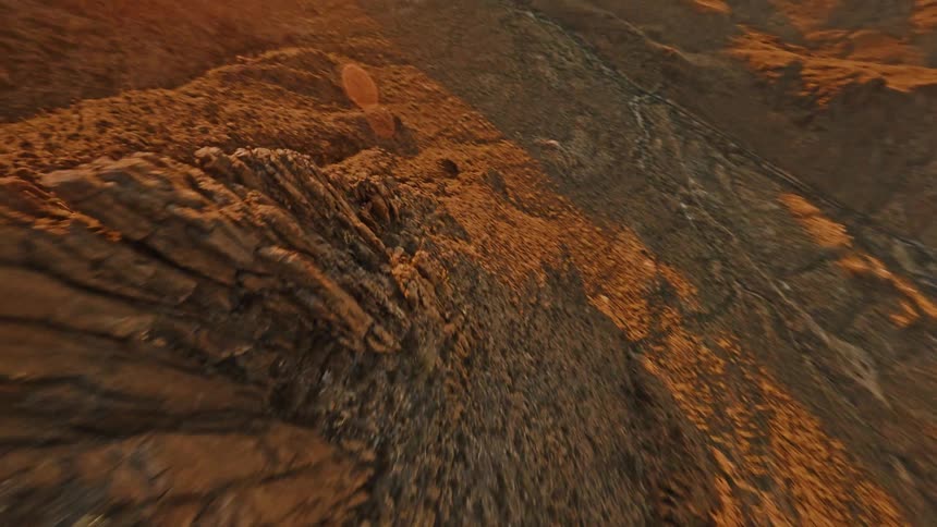 Desert area with mountains and hills around a valley outdoors during dusk or dawn