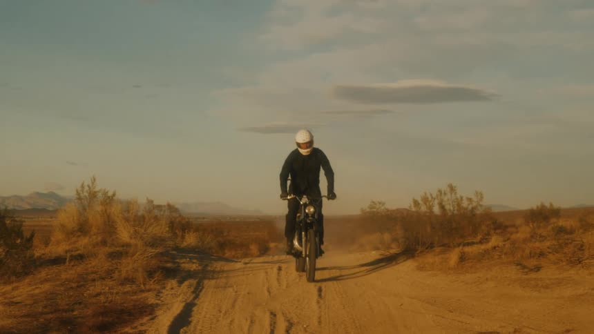 A man riding a dirt bike down a trail