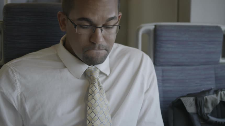 A man sits on a commuter train