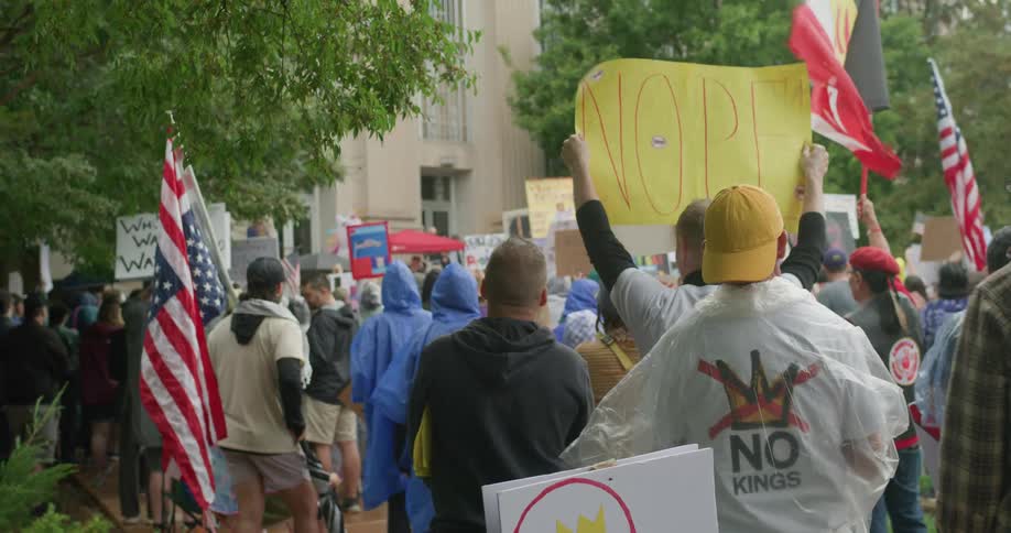 Signs reading nope held during protest in front of public building
