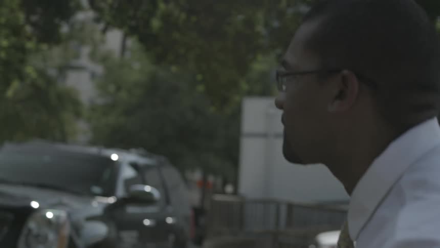 A man is walking outside on a cloudy day