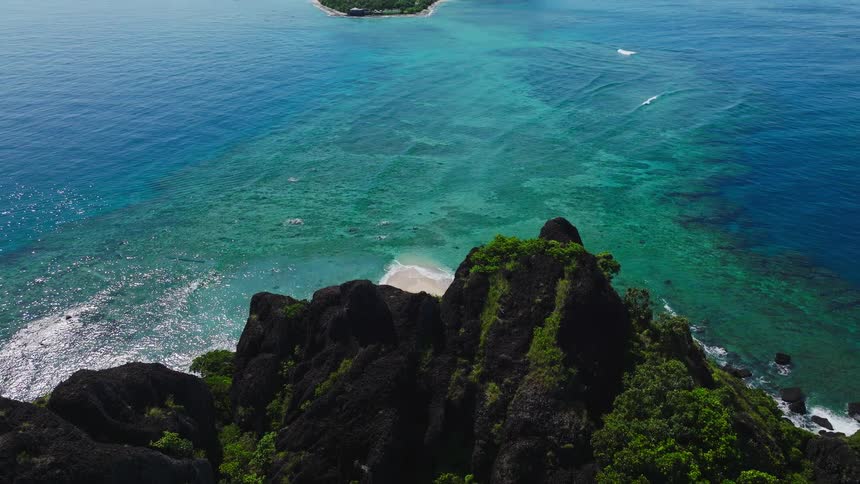 The small boat is anchored on the island shore