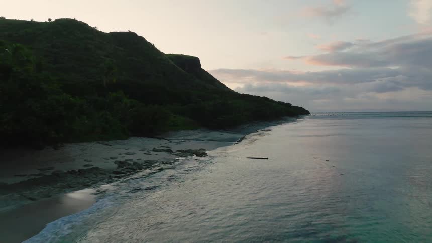 Green hills cover the tropical island