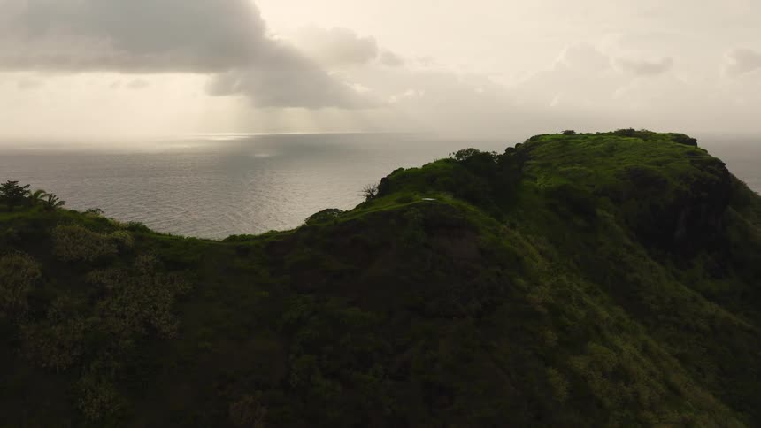 A view of a hill along the edge of a coast