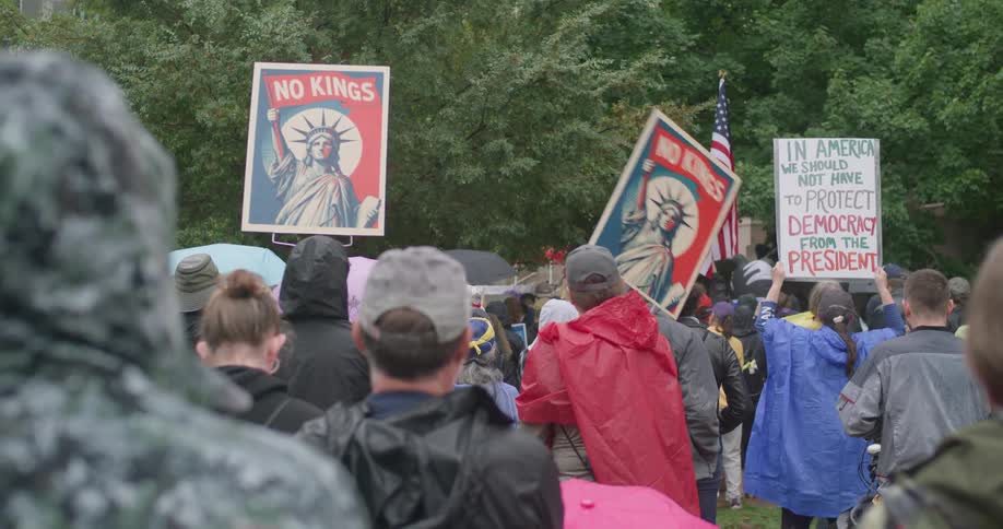 A group of people holding up signs outdoors