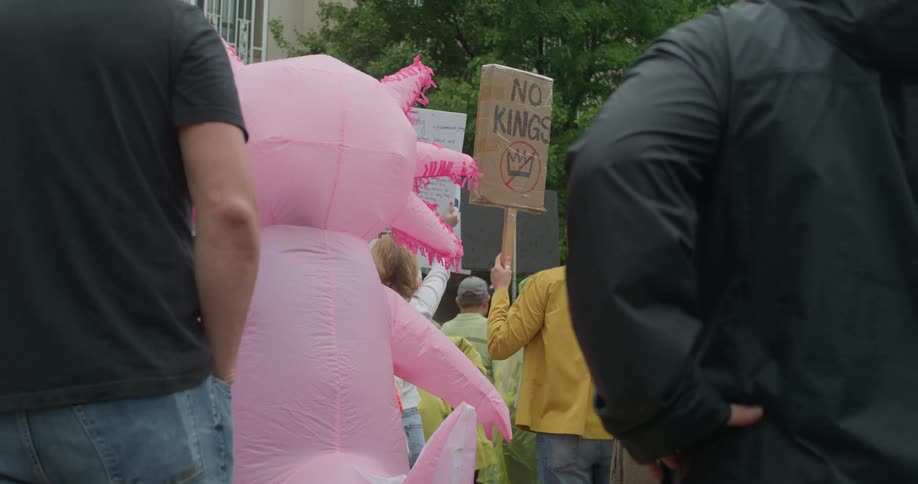 A group of people standing outdoors protesting