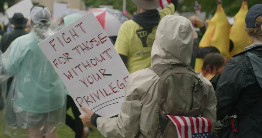 A group of people protesting with signs