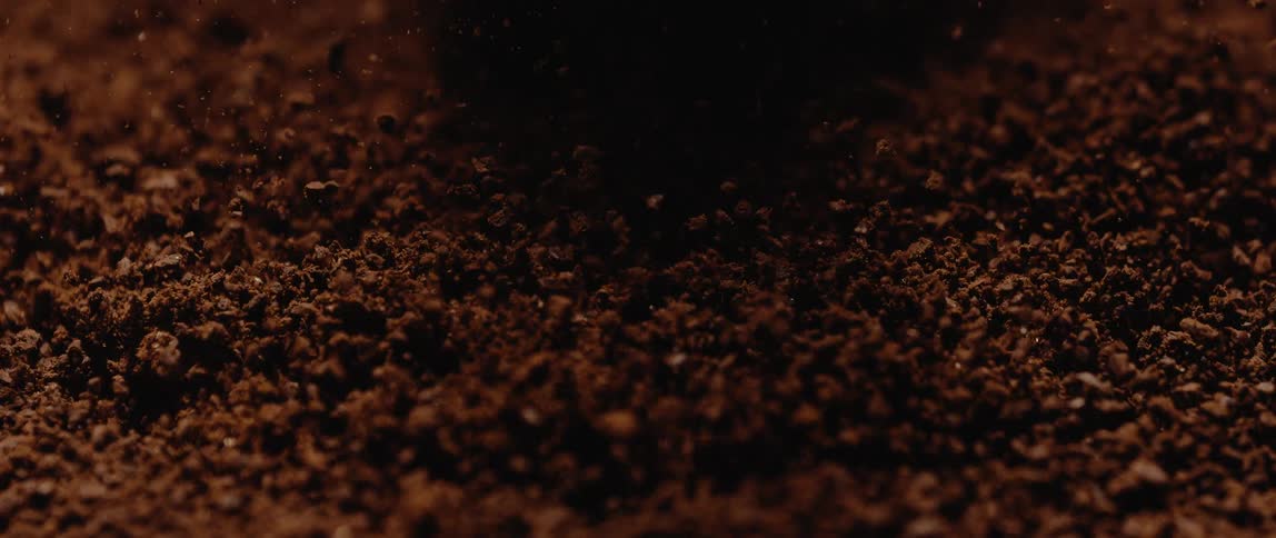 Closeup of pouring sand with shadows over it