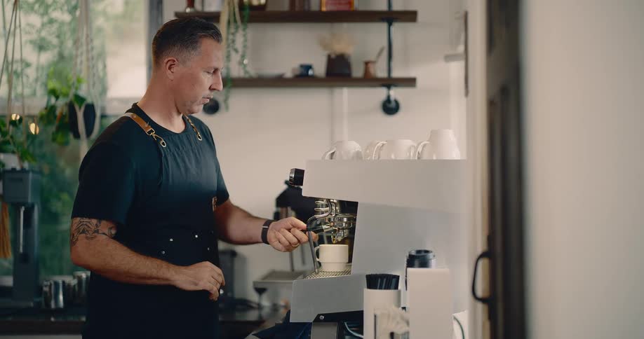 A man is making coffee in his kitchen