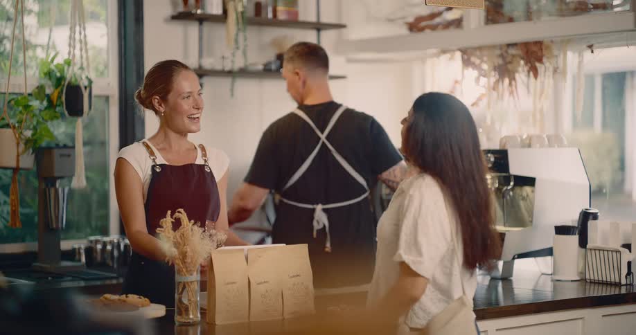 A customer approaches the counter to order in the coffee shop