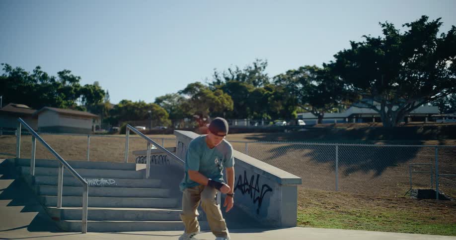 The teenager jumps his skateboard down the stairs