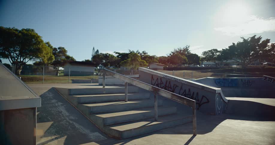 Teenage boy on a skateboard leaps over stairs and maintains balance on his skateboard