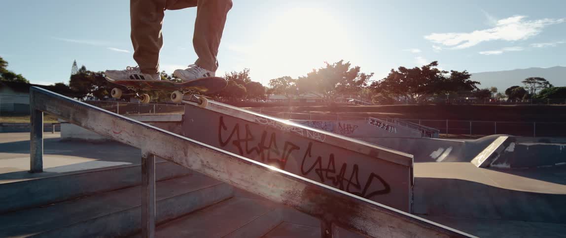 The skateboarder balances down the handrail