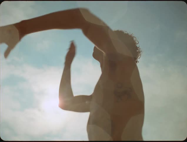 The man is playing volleyball on a sunny day