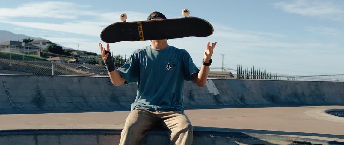 The teenager tosses up his skateboard