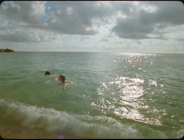 Two children run and play in the water