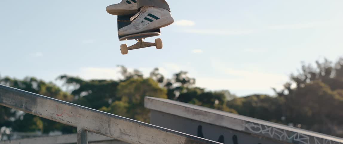 A man is riding a skateboard down the rails on a staircase