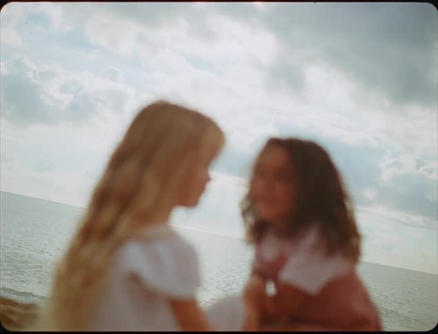 Two friends are talking on the beach