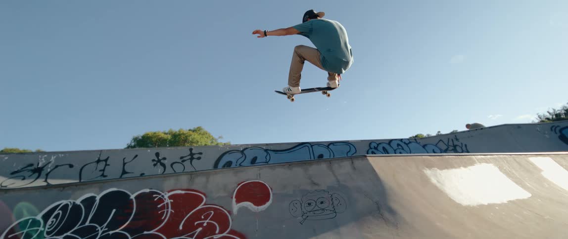 A teenage boy skateboarding outdoor at midday