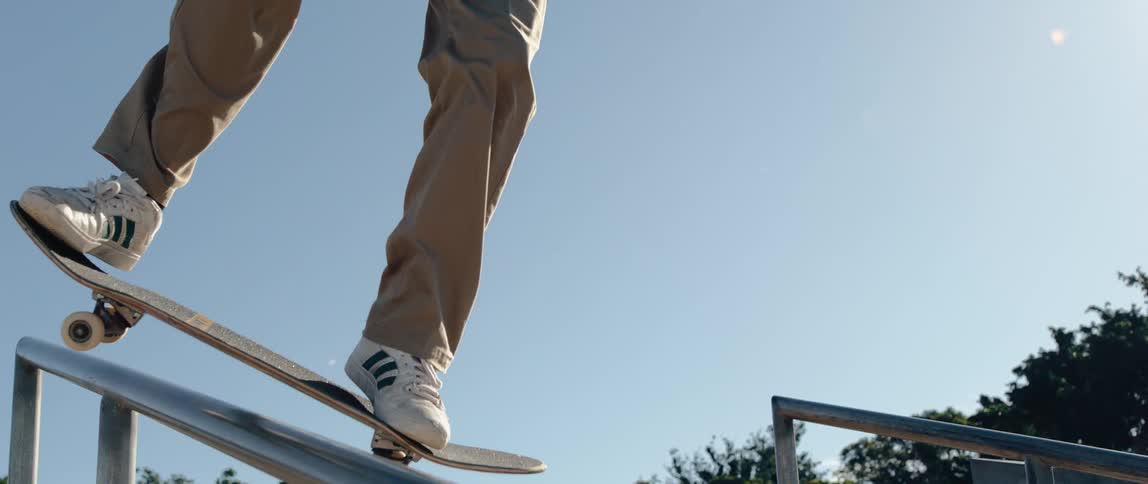 A man is riding a handrail with his skateboard
