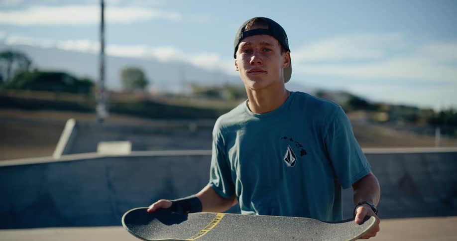 Skater spins the skateboard in the air using his hands during a stationary trick