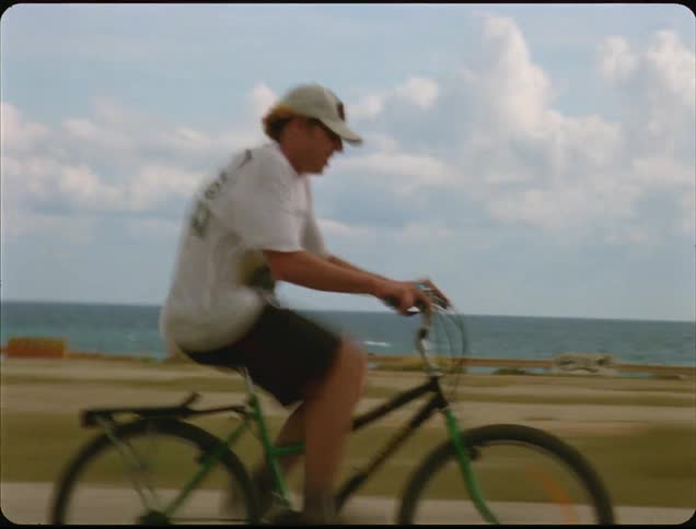 A man is riding a bike outdoors