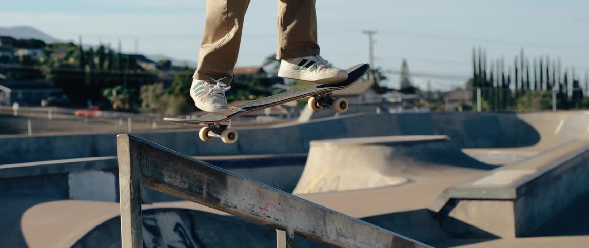 The person skateboarding jumps over the handrail