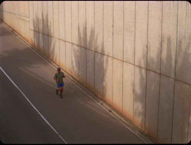 The man runs down the path