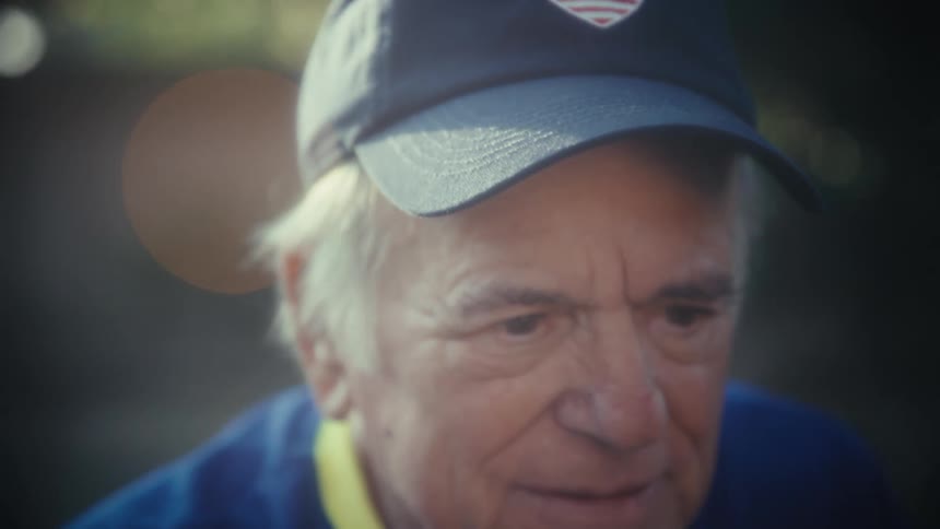 A man in a hat taking a selfie of his face