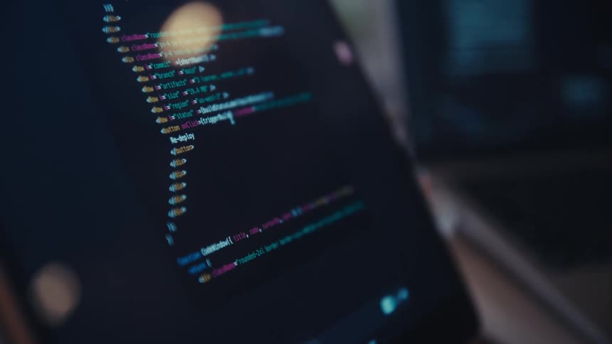 A computer screen displays lines of colorful programming code