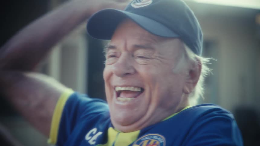 Elderly man thrilled while watching on his cell phone