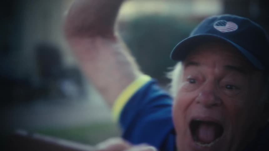 The man is excited and pointing in his yard