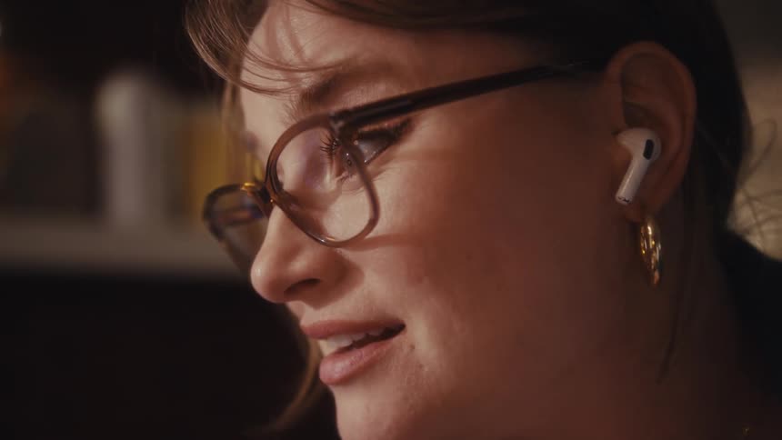 A woman with glasses discusses a document and the focus shifts to the graph on the paper she is holding