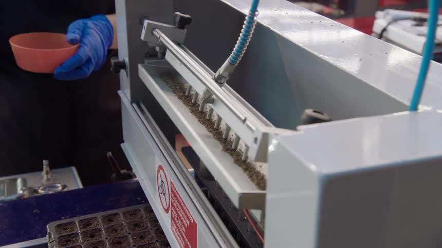 The worker operates the machine in the factory