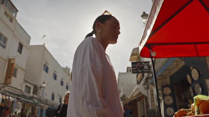 A woman looking to buy things from a street market
