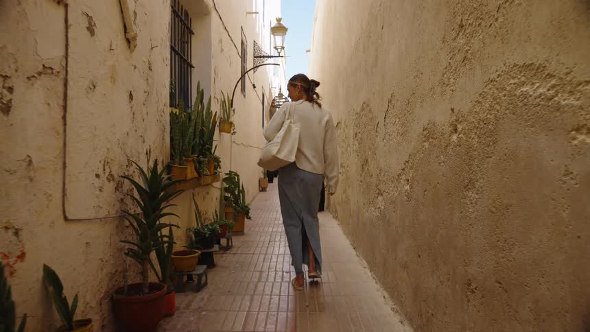 The woman walks down the alley