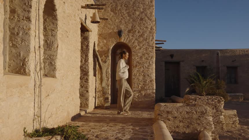 The woman walks out of the villa