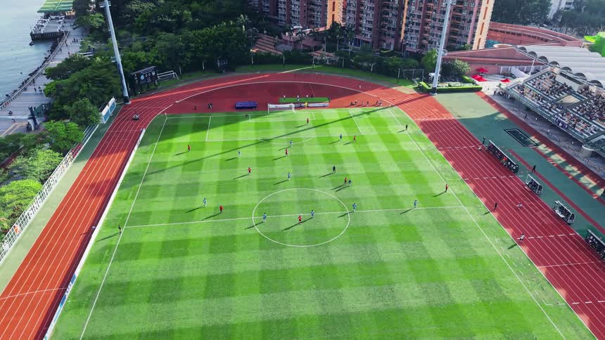 Aerial of a soccer game on a professional field in an urban area