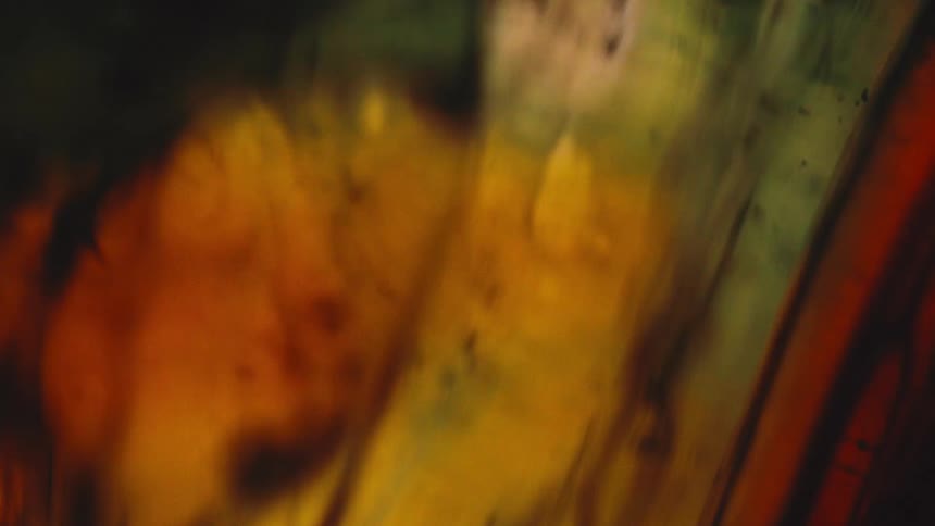 An abstract blend of warm colors flowing that features areas of yellow orange and deep red with blurred shapes