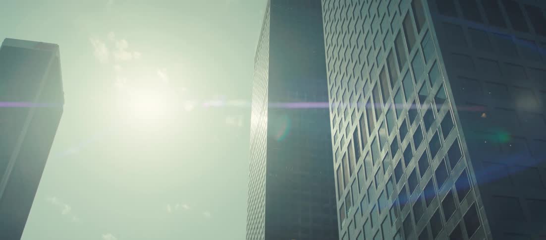 Skyscrapers in a city rise high above a bridge