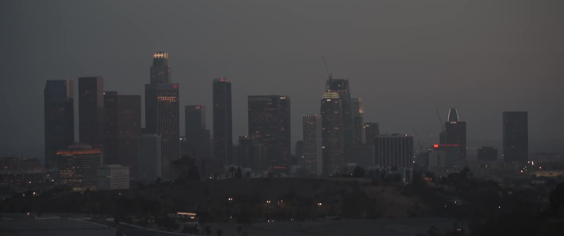 The buildings are brightly lit at dawn
