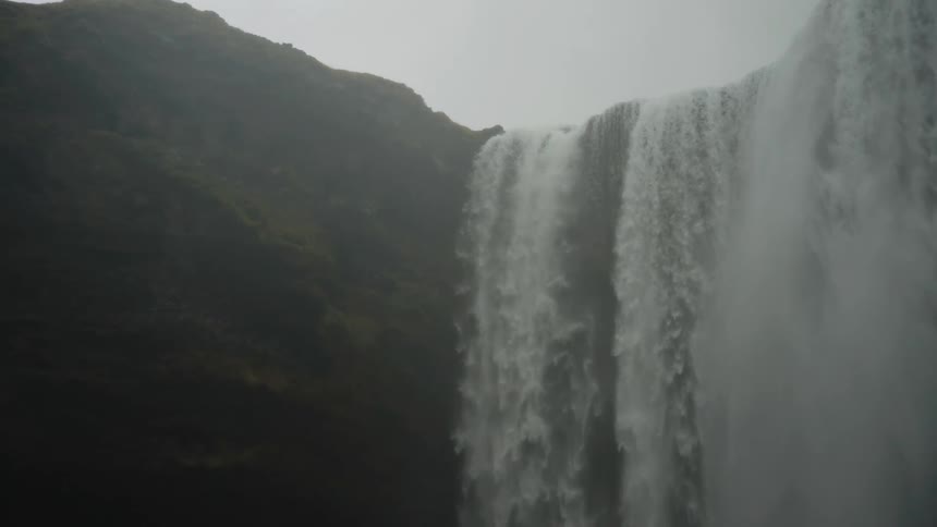 Massive waterfall flowing over a canyon in slow motion