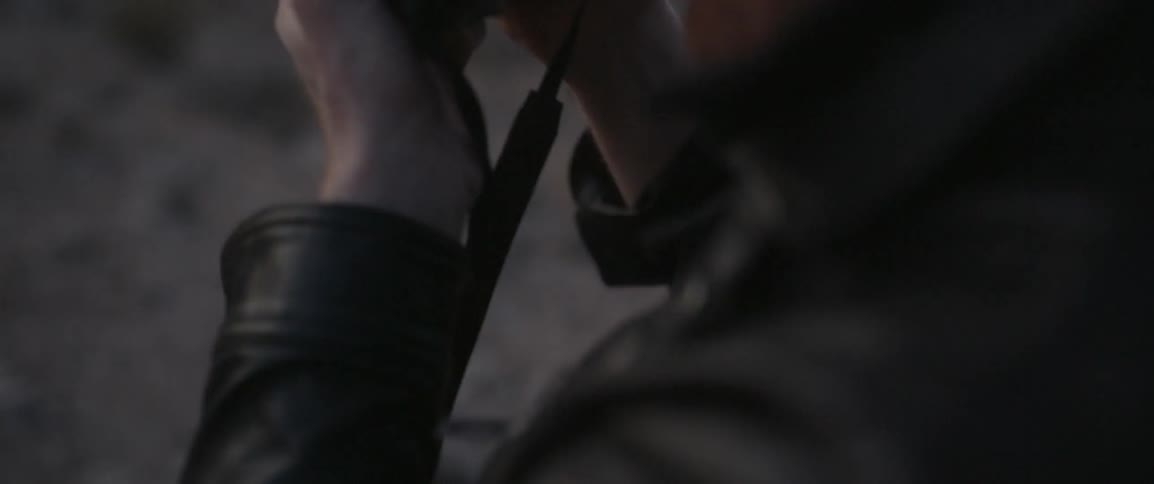 A man takes the cap off the lens and looks through the viewfinder