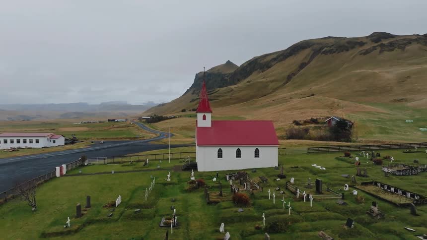 Remote small church with steeple in the countryside near a small graveyard
