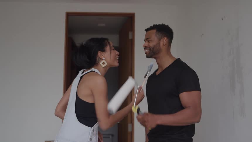 Two people in a room being renovated